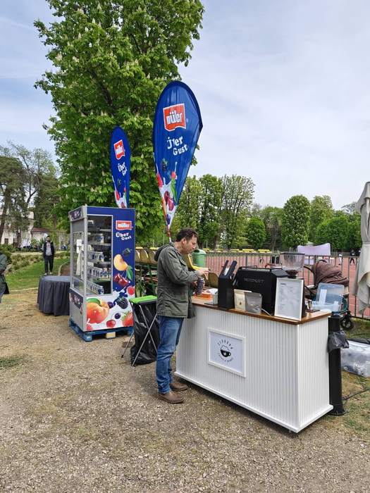 Bar de cafea mobil montat la un eveniment în aer liber, lângă o pistă de atletism